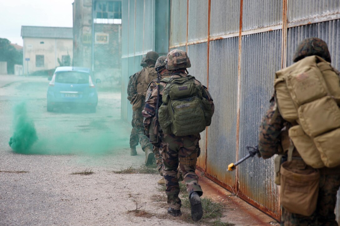 Marines with Special-Purpose Marine Air-Ground Task Force Crisis Response and Legionnaires from the 2nd Foreign Infantry Regiment of France's 6th Light Armored Brigade work side-by-side during a simulated heliborne raid Oct. 31, 2013, at Camp des Garrigues, France. The event was part of a week-long bilateral training exercise between U.S. Marines with SP-MAGTF Crisis Response and French Legionnaires. SP-MAGTF Crisis Response is a self-mobile, self-sustaining force capable of responding to a range of crises to protect both U.S. and partner-nation security interests in the region, as well as strengthening partnerships throughout the U.S. European Command and U.S. Africa Command area of responsibility. (U.S. Marine Corps photo by Cpl. Michael Petersheim)