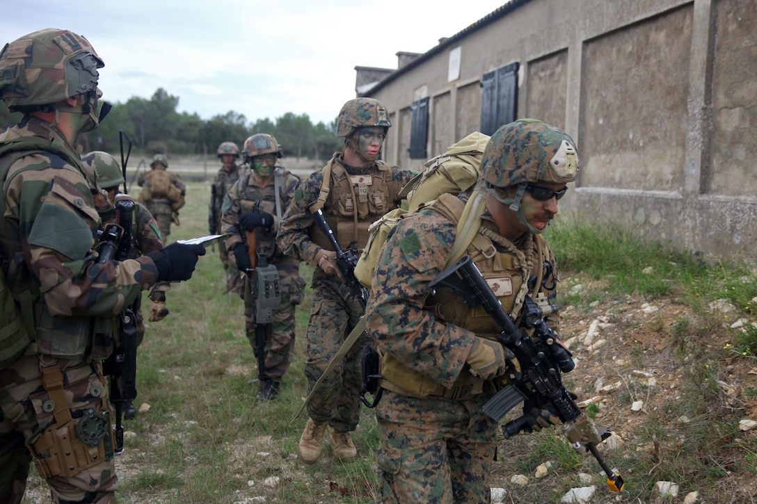 Marines and sailors with Special-Purpose Marine Air-Ground Task Force Crisis Response and Legionnaires from the 2nd Foreign Infantry Regiment of France's 6th Light Armored Brigade work side-by-side during a simulated heliborne raid Oct. 31, 2013, at Camp des Garrigues, France. The event was part of a week-long bilateral training exercise between U.S. Marines with SP-MAGTF Crisis Response and French Legionnaires. SP-MAGTF Crisis Response is a self-mobile, self-sustaining force capable of responding to a range of crises to protect both U.S. and partner-nation security interests in the region, as well as strengthening partnerships throughout the U.S. European Command and U.S. Africa Command area of responsibility. (U.S. Marine Corps photo by Cpl. Michael Petersheim)