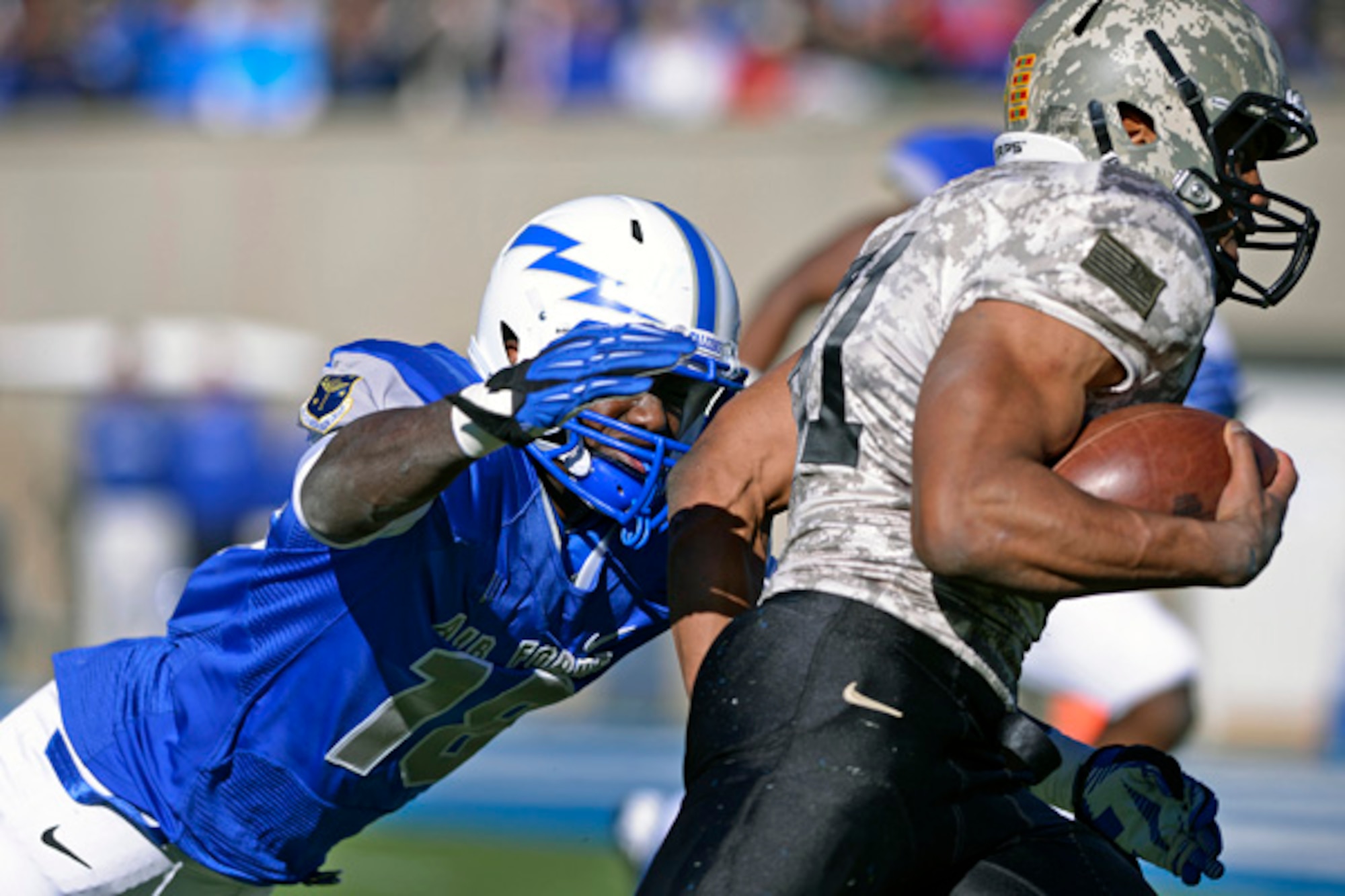 Air Force sophomore linebacker Reggie Barnes dives to tackle Army running back Terry Baggett Nov. 2, 2013, during the Air Force-Army football game at Falcon Stadium, Colorado Springs, Colo. The Falcons defense held the Black Knights to just seven points in the second half, giving Air Force a 42-28 victory.
