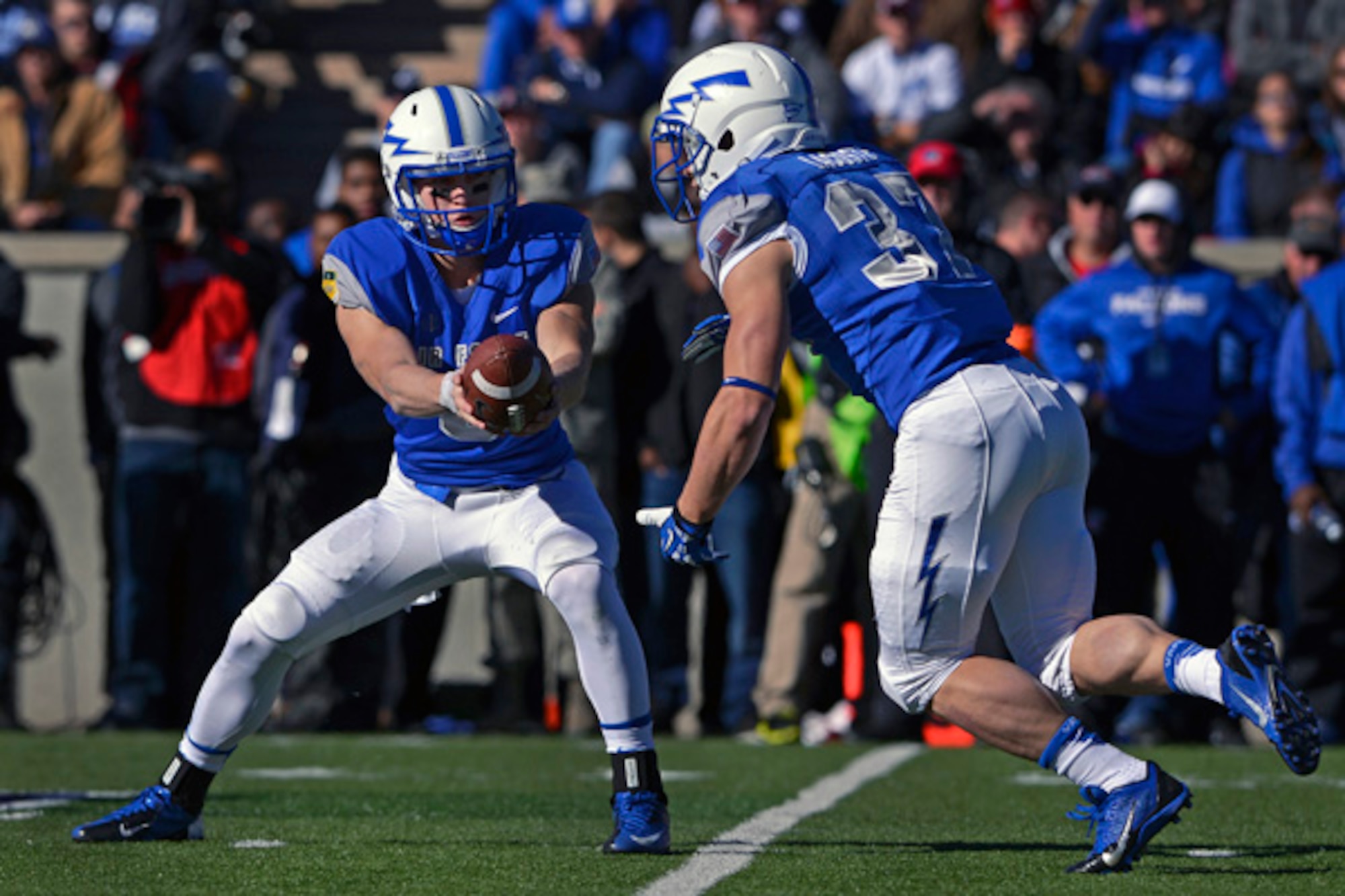 Air Force freshman quarterback Nate Romine hands off to senior running back Anthony LaCoste Nov. 2, 2013, during the Air Force-Army football game at Falcon Stadium, Colorado Springs, Colo. LaCoste scored on 73- and 78-yard runs to lead the Falcons over the Black Knights, 42-28.