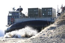 A Landing Craft Air Cushion makes landfall with personnel and equipment from the 26th Marine Expeditionary Unit at Onslow Beach, Camp Lejeune, N.C., Nov. 03, 2013. Service members with Combat Logistics Battalion 26, 2nd Marine Logistics Group supported the 26th MEU as the combat logistics element. (U.S. Marine Corps photo by Lance Cpl. Shawn Valosin)