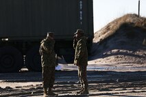 Pfc. Robinzon Loor (left) and Cpl. Bobby Weaver (right), landing support specialists with Landing Support Company, 2nd Marine Logistics Group maintain radio contact with incoming vessels and vehicles from the 26th Marine Expeditionary Unit during offloading operations aboard Camp Lejeune, N.C., Nov. 03, 2013. LS Co. worked in unison with Navy Beach Master Unit Two to help unload service members and vehicles from the 26th MEU’s ships. (U.S. Marine Corps photo by Lance Cpl. Shawn Valosin)