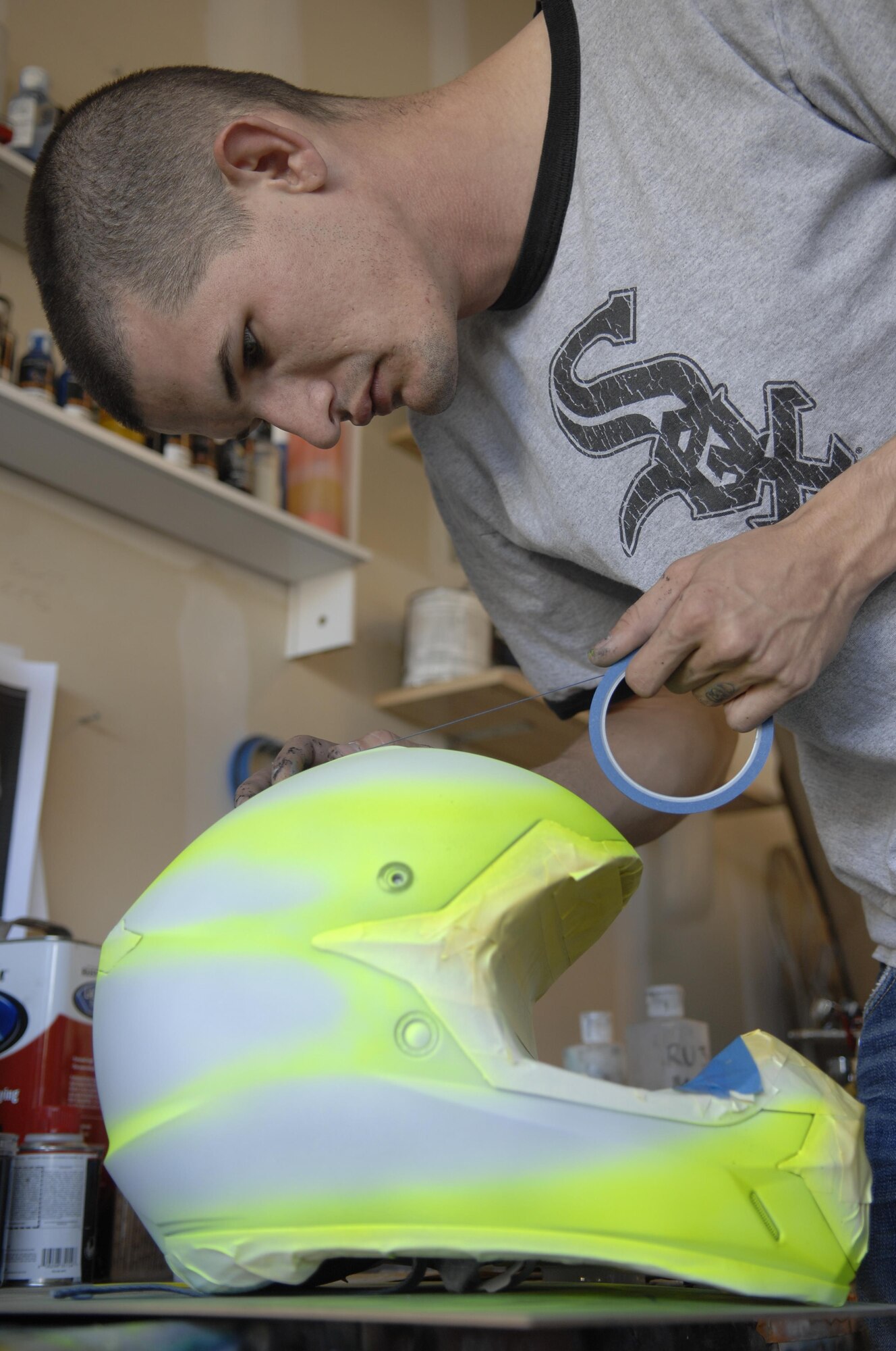 U.S. Air Force Senior Airman Patrick Corcoran tapes guidelines on a project Oct. 30, 2013 at Davis-Monthan Air Force Base, Ariz. Corcoran is airbrushes in his free time as a hobby. Corcoran is a 755th Aircraft Maintenance Squadron propulsion technician.