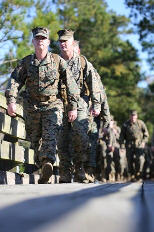 Marines with Marine Aviation Logistics Squadron 29 cross a bridge as they participate in a six-mile motivational hike, Nov. 4. The Marines reached their hiking destination and boarded CH-53E Super Stallions for transport to their origin point.