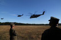 Marines with Marine Aviation Logistics Squadron 29, look on as CH-53E Super Stallions transport Marines back to Marine Corps Air Station New River after a six-mile hike, Nov. 4.