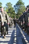 Marines with Marine Aviation Logistics Squadron 29 cross a bridge as they participate in a six-mile motivational hike, Nov. 4. The Marines reached their hiking destination and boarded CH-53E Super Stallions for transport to their origin point.