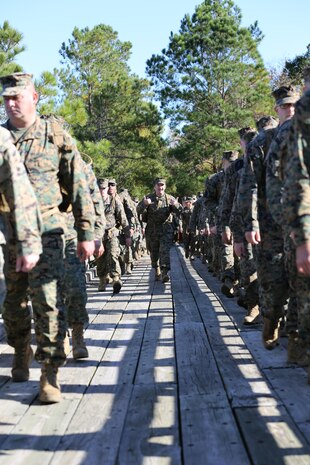 Marines with Marine Aviation Logistics Squadron 29 cross a bridge as they participate in a six-mile motivational hike, Nov. 4. The Marines reached their hiking destination and boarded CH-53E Super Stallions for transport to their origin point.