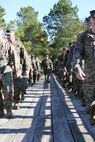 Marines with Marine Aviation Logistics Squadron 29 cross a bridge as they participate in a six-mile motivational hike, Nov. 4. The Marines reached their hiking destination and boarded CH-53E Super Stallions for transport to their origin point.