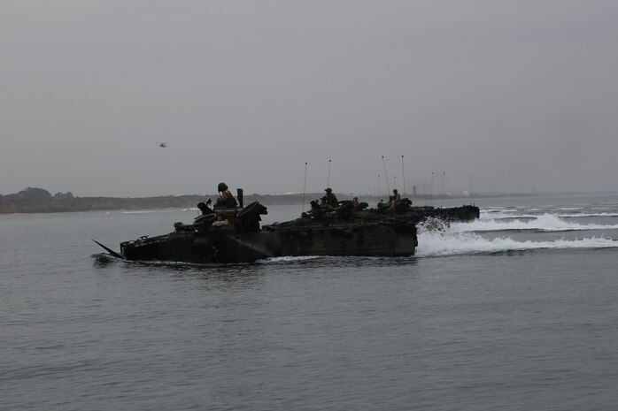 Marines with Headquarters and Service Company, 3rd Assault Amphibian Battalion, navigate AAVs aboard the USS Pearl Harbor during an amphibious training exercise in support of well deck operations here, Oct. 24, 2013. The training took place off the coast of Camp Pendleton to train and evaluate the Marines in wet well procedures and the tactical employment of AAVs in the water and on land.