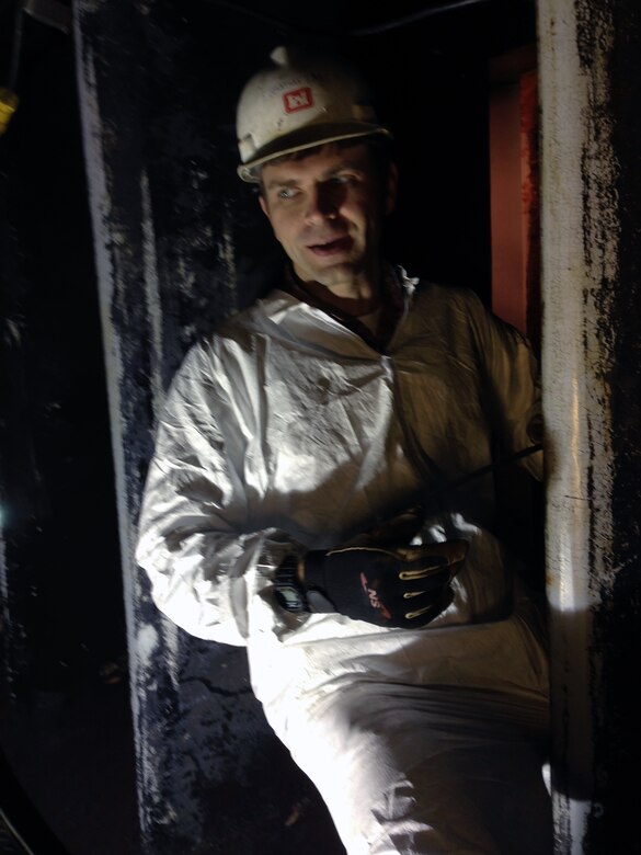 Jonathan Sims, a journeyman mechanic works inside the penstock on wicket gates located inside the Laurel River Dam.  A group of electrical and mechanical engineers from the Wolf Creek power plant are performing routine maintenance.  