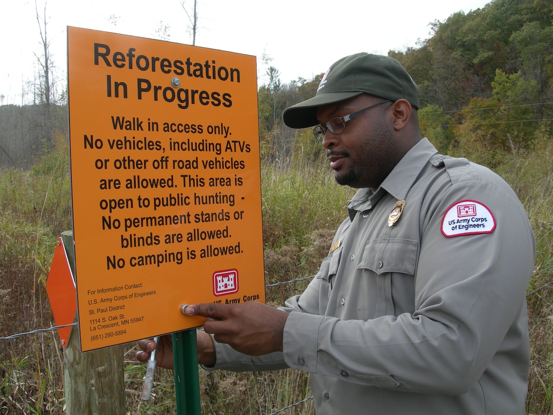 St. Paul District forester Bobby Jackson installs a sign on Lock and Dam 3 mitigation property near Maiden Rock, Wis. The recent construction of navigation improvements on the embankments at Lock and Dam #3, resulted in the loss of vital environmental features in the floodplain. As part of our efforts to mitigate these impacts, the St. Paul District purchased 520 acres along the Rush and Trimbelle Rivers in Pierce Co., Wis., restoring 313 of those acres back to native floodplain forest. This isn’t unique to the district. Read more about another reforestation project on a Mississippi River island near Red Wing, Minn.: 
http://go.usa.gov/WB3W