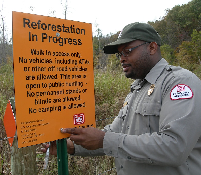 St. Paul District forester Bobby Jackson installs a sign on Lock and Dam 3 mitigation property near Maiden Rock, Wis. The recent construction of navigation improvements on the embankments at Lock and Dam #3, resulted in the loss of vital environmental features in the floodplain. As part of our efforts to mitigate these impacts, the St. Paul District purchased 520 acres along the Rush and Trimbelle Rivers in Pierce Co., Wis., restoring 313 of those acres back to native floodplain forest. This isn’t unique to the district. Read more about another reforestation project on a Mississippi River island near Red Wing, Minn.: <a href="http://go.usa.gov/WB3W" rel="nofollow">go.usa.gov/WB3W</a>
USACE photo by Randy Urich