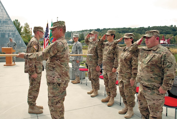 Rick Petersen, Michael Suh, Allison Bruner, David Nishimura, Sgt. 1st Class Michael Bamba, and Maj. Toby Flinn of the 34th Engineer Detachment, FEST-A, cased its colors on Sept. 28 as the last step of their preparation for deployment to Afghanistan.
