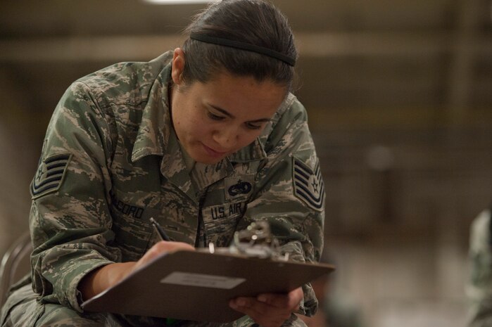 Tech. Sgt. Jaclyn McCord, 99th Logistics Readiness Squadron NCO in charge of vehicle management and analysis, checks a list of items during an operation readiness exercise Nov. 5, 2013, at Nellis Air Force Base, Nev. The exercise tested the wing's capability to deploy combat power for our nation, wherever and whenever needed worldwide. (U. S. Air Force photo by Airman 1st Class Christopher Tam)