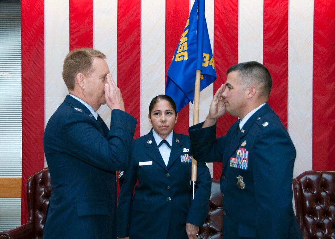 TRAVIS AIR FORCE BASE, Calif. -- Col. Stuart Toft, 349th Mission Support Group commander, salutes Lt. Col. Andrew Frankel, the new 349 Security Forces Squadron commander, after officially passing the guidon to Frankel. (U.S. Air Force photo/Senior Master Sgt. Robert Wade) 