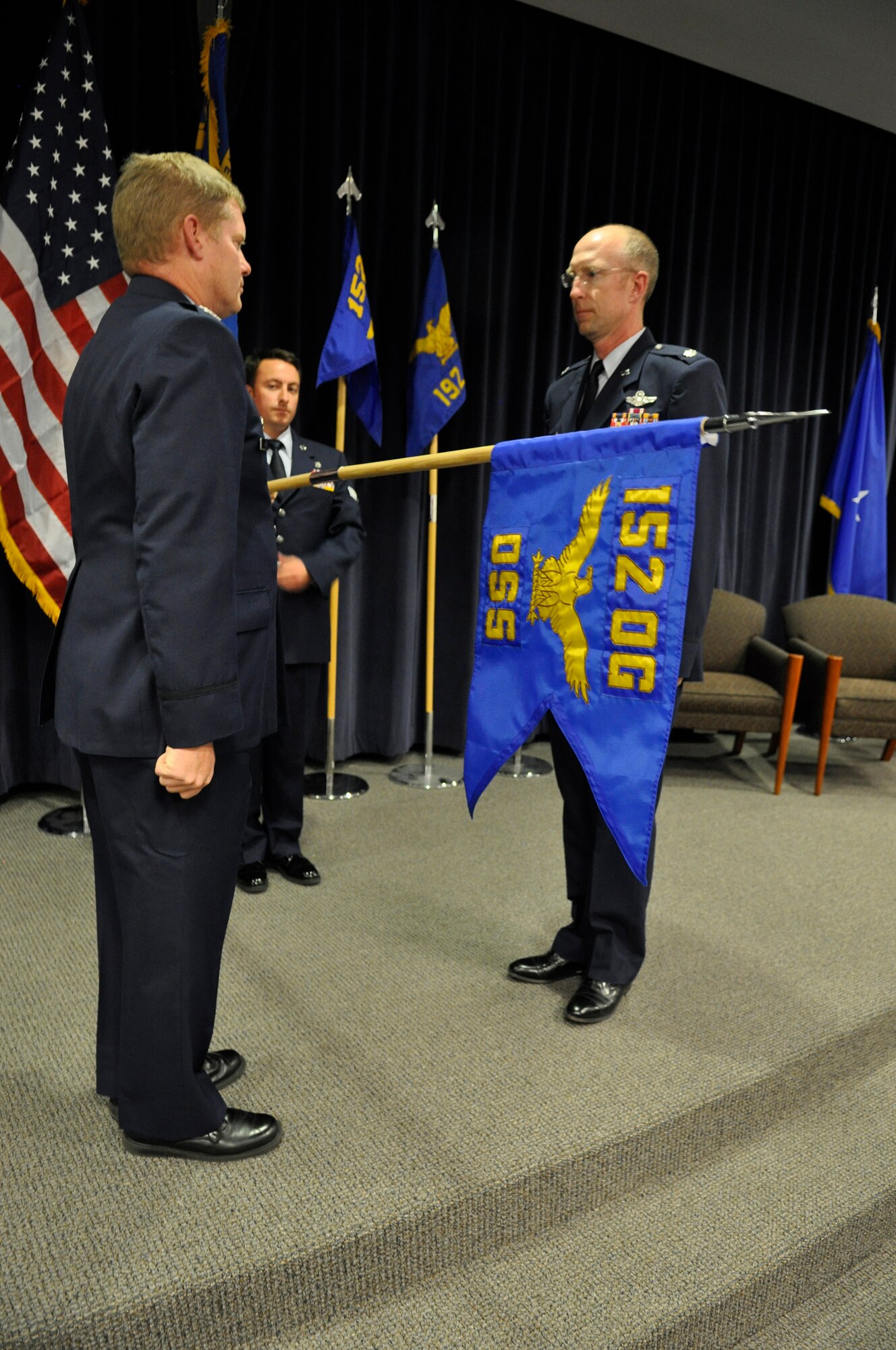 152nd Operation’s Group Command, Col. Kyle Reid (left) presents the guidon to incoming commander of the new 152nd Operation Support Squadron (OSS), Lt. Col. Jon Schulstad. The unit went live November 2 during an unveiling ceremony at the Nevada Air National Guard base in Reno, Nevada. The unit’s role will be to provide the members of the 152nd Operations Group with a more streamline and focused training program pilots and crews need in order to always be mission-ready at any time.
“Since we were able to get the manning we needed to stand up this new unit, we will now have the resources to have a unit devoted to just our training needs,” said Schulstad. 
Schulstad added, having a unit devoted to training expressly helps with the overall mission. It frees up the operation’s side of the group to do more of their war-fighting work rather than having to take precious time away from them to do their own training schedules.
