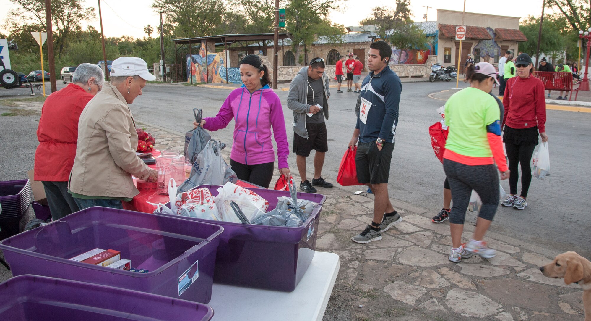 Participants of the 3rd annual Running with the Bulls event donate food items to support Val Verde Loaves and Fishes, Del Rios largest local food pantry, Del Rio, Texas, Nov. 2, 2013. The event featured more than 500 runners, raising more than $50,000, and collecting 3,000 pounds of food donations. (U.S. Air Force photo/Senior Airman Maysonet)
