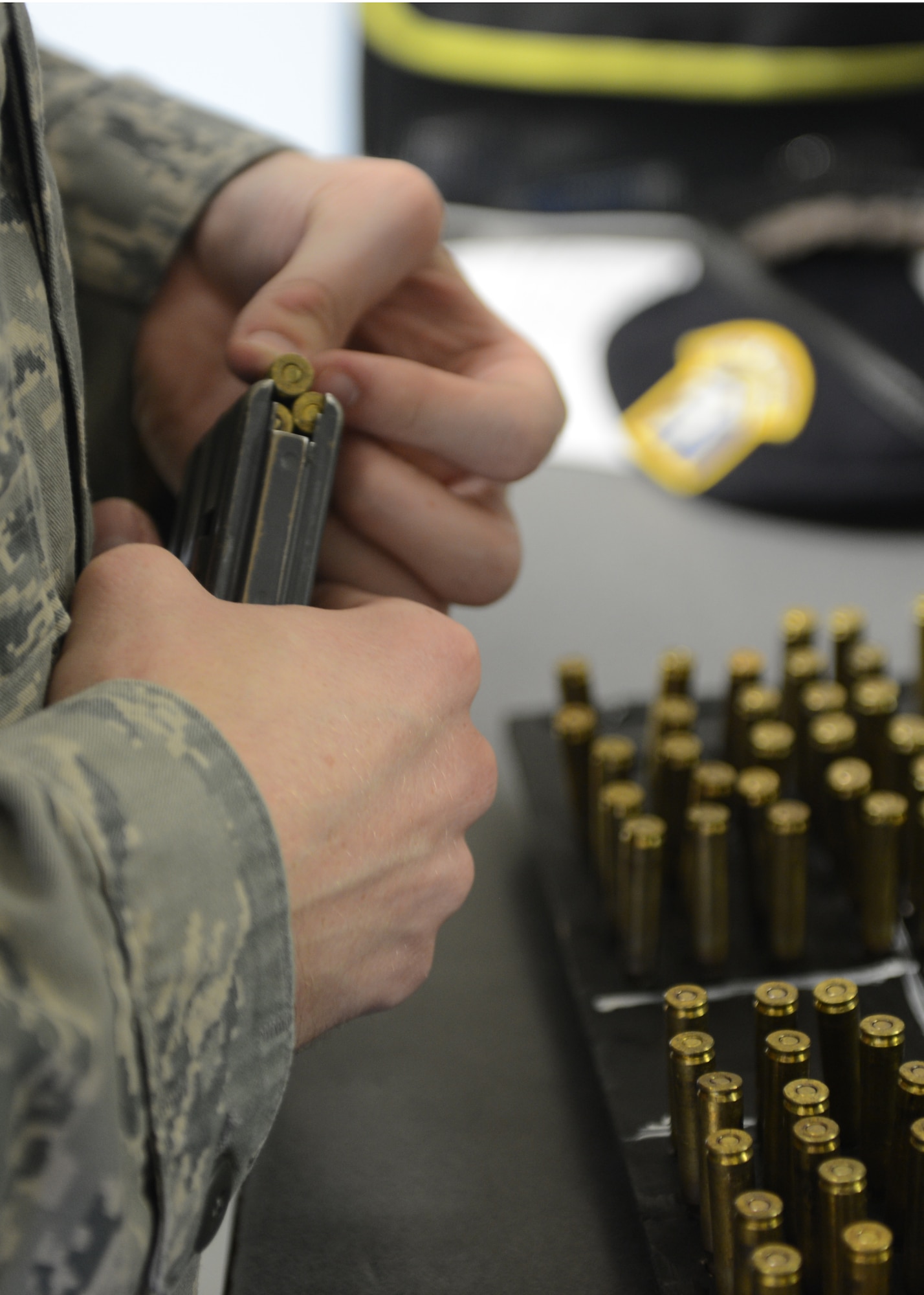 A 20th Security Forces Squadron Airman reloads rounds into a M4 rifle magazine at Shaw Air Force Base, S.C., Oct. 15, 2013. After inspection for serviceability by an armorer, Airmen are responsible for reloading their issued magazines. (U.S. Air Force photo by Tech. Sgt. Frank Miller/Released)