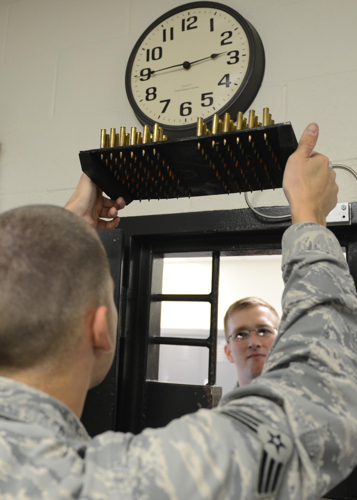 U.S. Air Force Senior Airman Richard Sapp, 20th Security Forces Squadron armorer, inspects ammunition prepared by Airman 1st Class David Bowman, 20th SFS security forces journeyman, at Shaw Air Force Base, S.C., Oct. 15, 2013. Sapp checked the ammunition to ensure all rounds from the set of magazines were accounted for. (U.S. Air Force photo by Tech. Sgt. Frank Miller/Released)