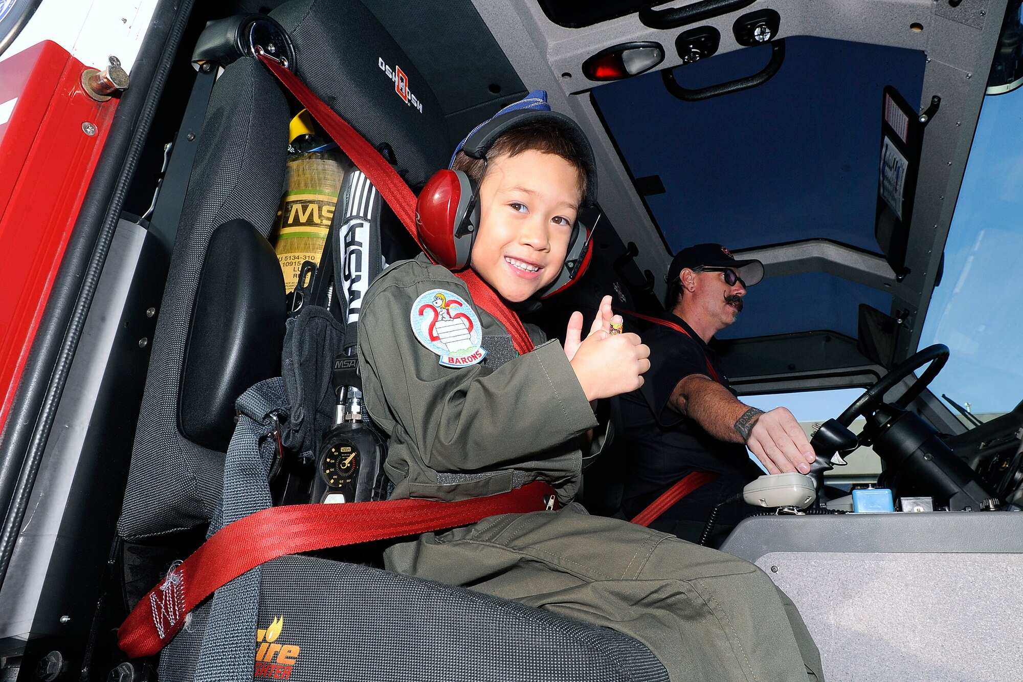 Aidan Peters, the Academy's latest Cadet for a Day, sits in a 10th Civil Engineer Squadron fire truck near fire station 3 at the Academy Oct. 25. As part of his Cadet for a Day schedule, Aidan toured the fire department. The Cadet for a Day program is the result of ongoing teamwork between the Cadet Wing and the Make-a-Wish-Foundation. 