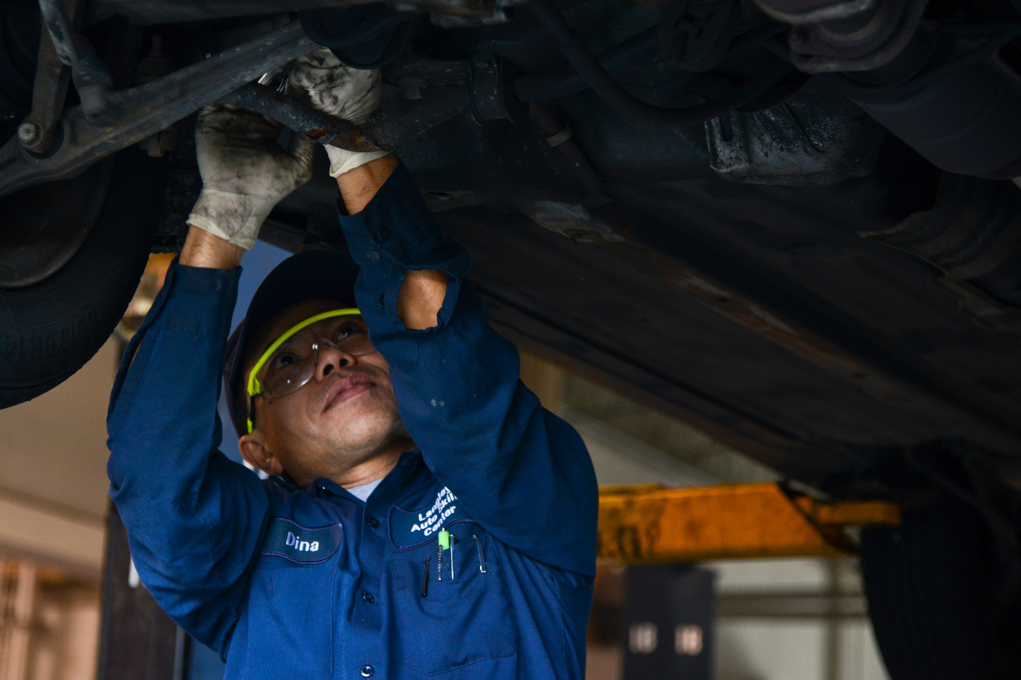 Dyna Nam, a contracted mechanic, performs maintenance on a customer's vehicle on a lift at the Auto Skills Shop at Langley Air Force Base, Va., Nov. 5, 2013. Whether scheduling routine maintenance or preparing vehicles for holiday travel, the Auto Skills Shop offers automotive services to meet the needs of the Joint Base Langley-Eustis community. (U.S. Air Force photo by Senior Airman Jason J. Brown/Released)
