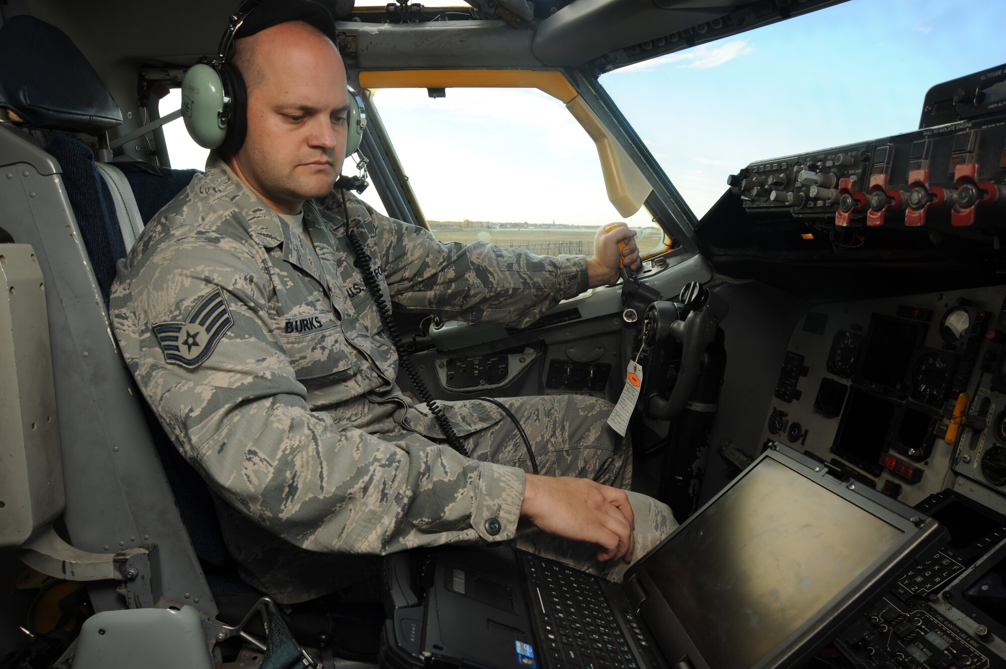 Staff Sgt. Kyle Burks, 22nd Maintenance Squadron electrical environmental craftsman, checks technical orders on a laptop Nov. 1, 2013, at McConnell Air Force Base, Kan.  Technical orders contain methods and procedures to operate, modify and inspect equipment. (U.S. Air Force photo/Senior Airman Maurice A. Hodges)
