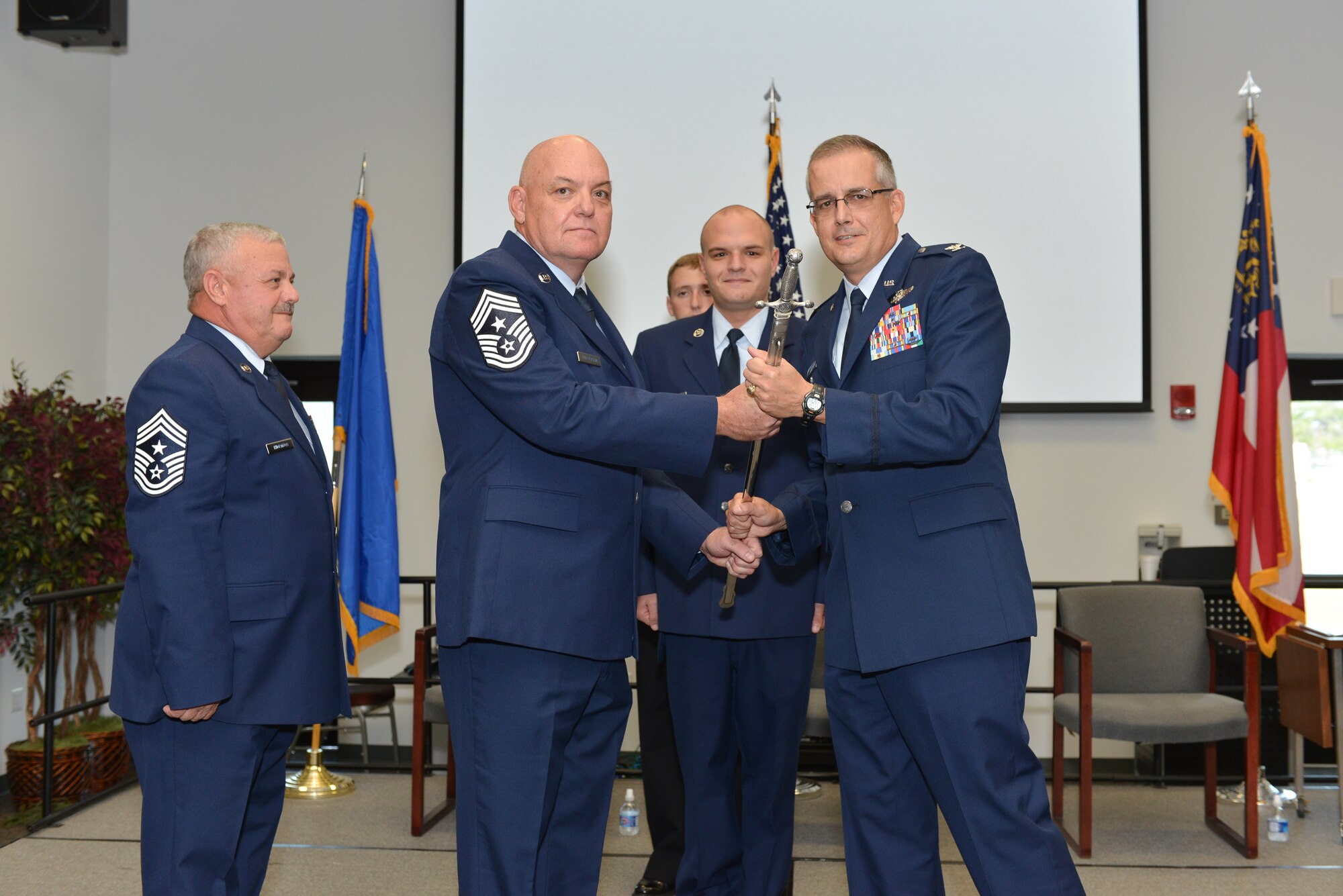 165th Airlift Wing Chief Master Sgt. Roy Patterson receives the sword of office from Col. Rainer Gomez, 165AW Air Commander, November 2, 2013 during a change of responsibility ceremony held at Savannah Air National Guard Base in Garden City, Ga. Patterson assumes the duties of Command Chief from Chief Master Sgt. Hewshal Thornton who held the senior enlisted position since 2007. (U.S. Air National Guard photo by Staff Sgt. Noel Velez-Crespo/released)