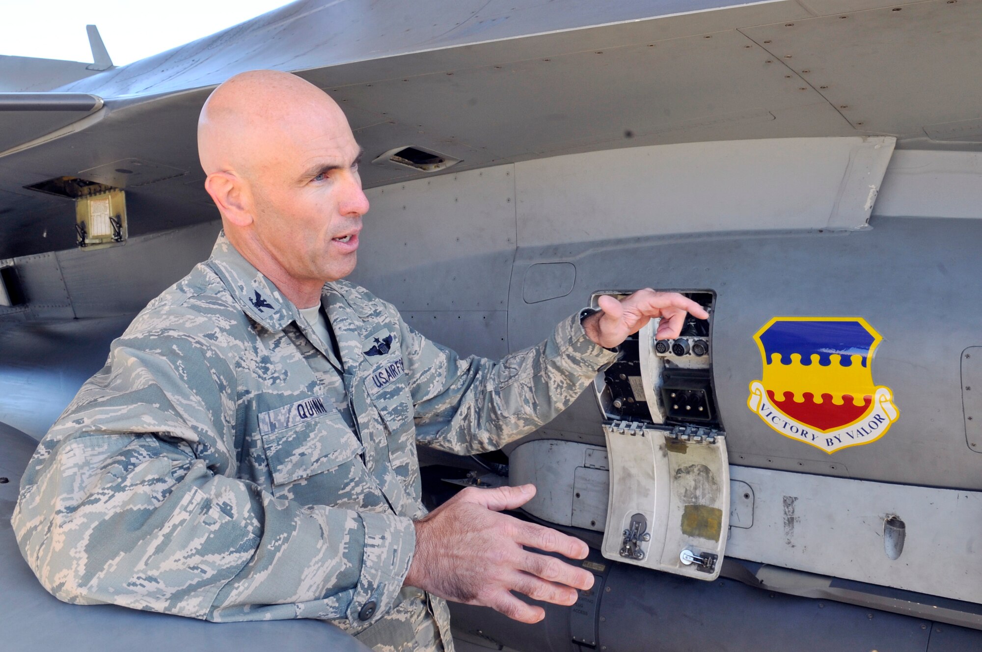 U.S. Air Force Col. Clark Quinn, 20th Fighter Wing vice commander, gives an orientation on the F-16 Fighting Falcon after learning how to refuel the aircraft Oct. 24, 2013, at Shaw Air Force Base, S.C. Quinn spent time on the flightline observing and participating in refueling operations. (U.S. Air Force photo by Airman 1st Class Jonathan Bass/Released)