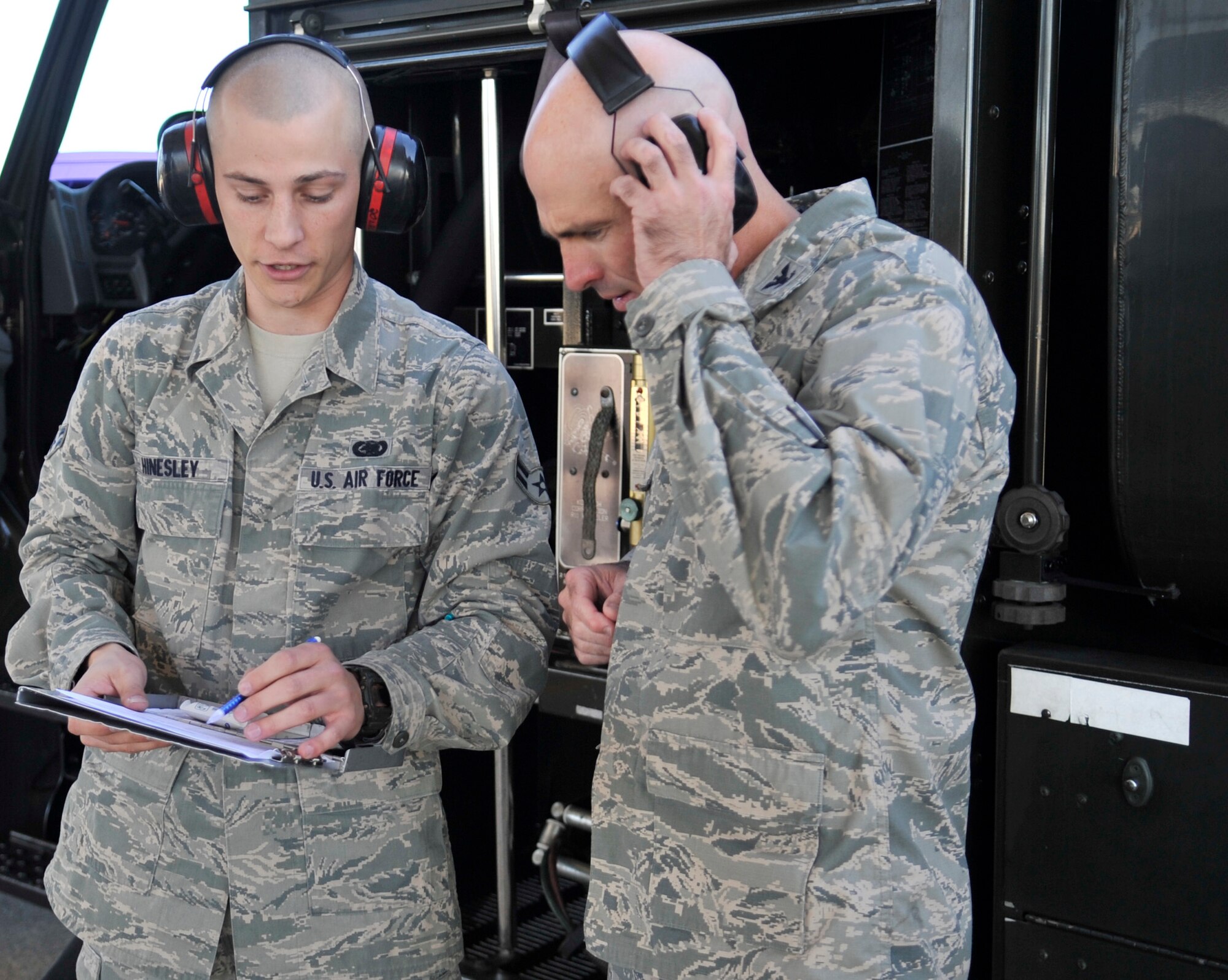 U.S. Air Force Col. Clark Quinn, 20th Fighter Wing vice commander, visited the flightline Oct. 24, 2013, at Shaw Air Force Base, S.C., and learned how “fuels” Airmen perform their job. U.S. Air Force Airman 1st Class Jonathan Hinesley, 20th Logistic Readiness Squadron fuel distribution operator, gave Quinn the crash course in refueling. Quinn then gave Hinesley an orientation on the capabilities of Shaw’s F-16s. (U.S. Air Force photo by Airman 1st Class Jonathan Bass/Released)