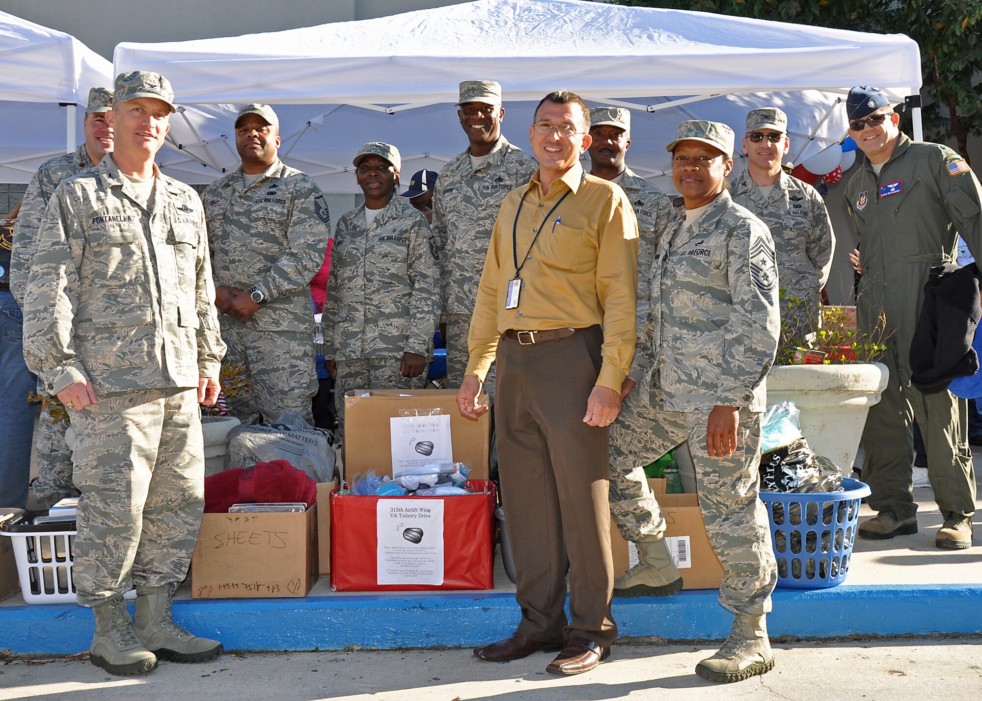 Members of the 315th Airlift Wing donated more than 50 boxes of toiletries and comfort items to benefit Lowcountry homeless and hospitalized veterans who receive care at the Ralph H. Johnson VA Medical Center downtown last week. In this photo taken at the VA after the Charleston Veterans Day Parade Sunday are (from left) Maj. Wayne Capps, 315th Public Affairs, Col. James Fontanella, 315th AW commander, Master Sgt. Anthony Gray, 315th Maintenance Squadron, Master Sgt. Martha Sass, 317th Airlift Squadron, Master Sgt. Bernard Graham, 315th Maintenance Operations Flight, Fred Lesinski, Charleston VA Voluntary Services, Chief Master Sgt. Gigi Manning, 315th AW command chief, Senior Master Sgt. Harold Vinson, Yellow Ribbon Program, Lt. Col. Steve Nathenson, Aerospace Medicine Squadron. (U.S. Air Force Reserve photo by Senior Airman Bobby Pilch)