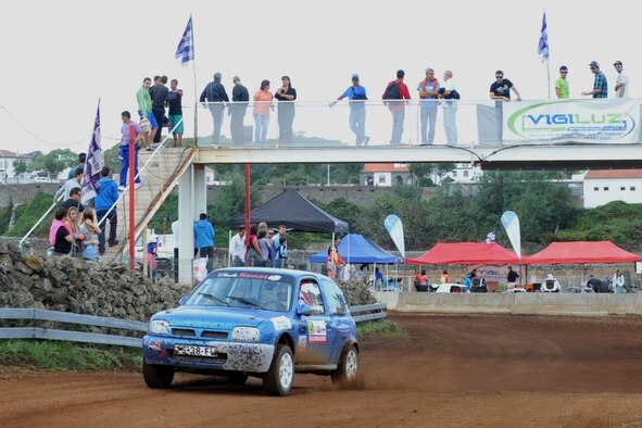 U.S. Air Force Staff Sgt. Joshua VanHorn, 65th Medical Operations Squadron medical technician, competes during a rally race in Praia da Vitoria, Azores. VanHorn participates in car races with Portuguese local nationals in the Azores while building friendships and host nation relations within the local community. As the only U.S. participant, VanHorn displays an American flag with his last name on his rear driver's-side window. (U.S. Air Force photo by Staff Sgt. Angelique N. Smythe/Released)