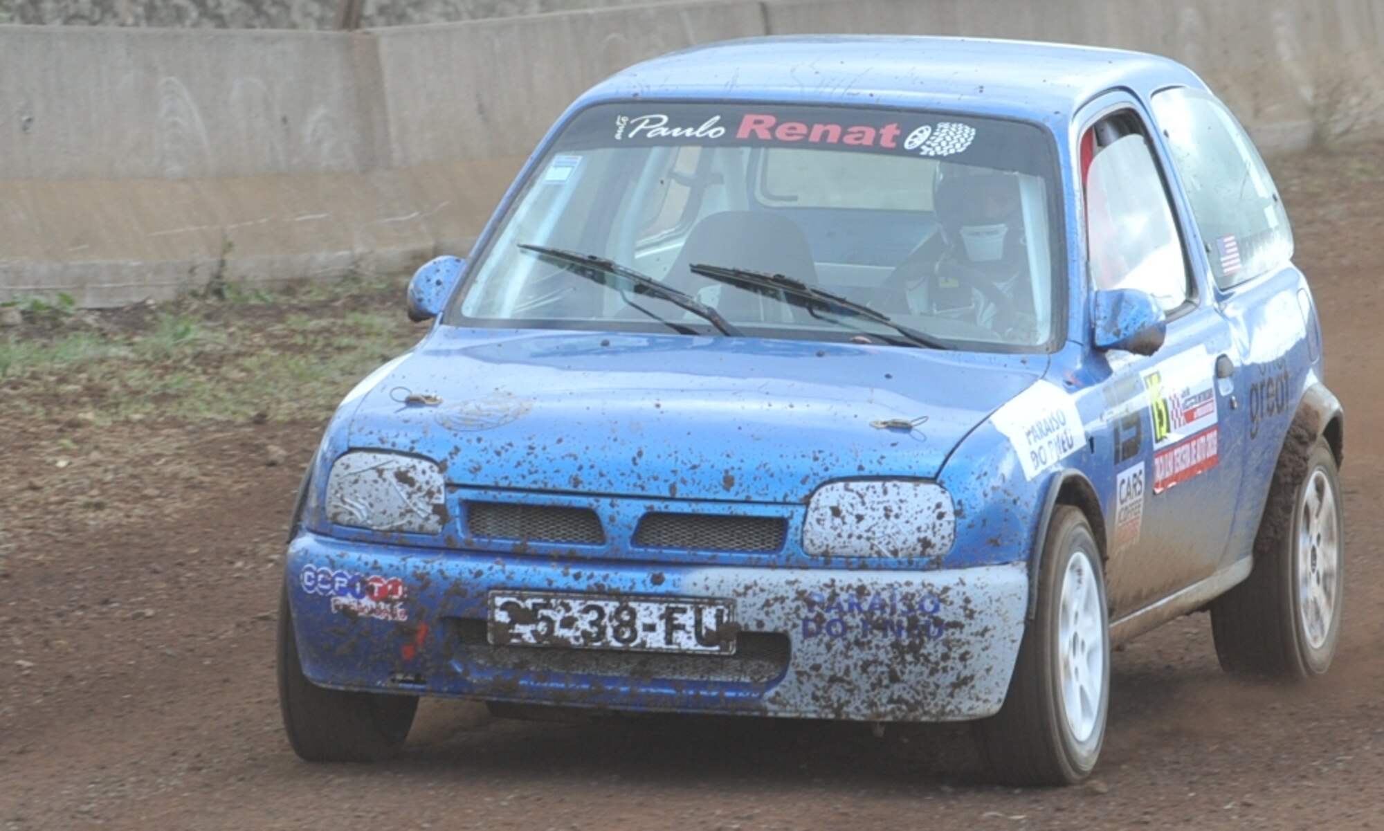 U.S. Air Force Staff Sgt. Joshua VanHorn, 65th Medical Operations Squadron medical technician, competes during a rally race in Praia da Vitoria, Azores. VanHorn participates in car races with Portuguese local nationals in the Azores while building friendships and host nation relations within the local community. As the only U.S. participant, VanHorn displays an American flag with his last name on his rear driver's-side window. (U.S. Air Force photo by Staff Sgt. Angelique N. Smythe/Released)