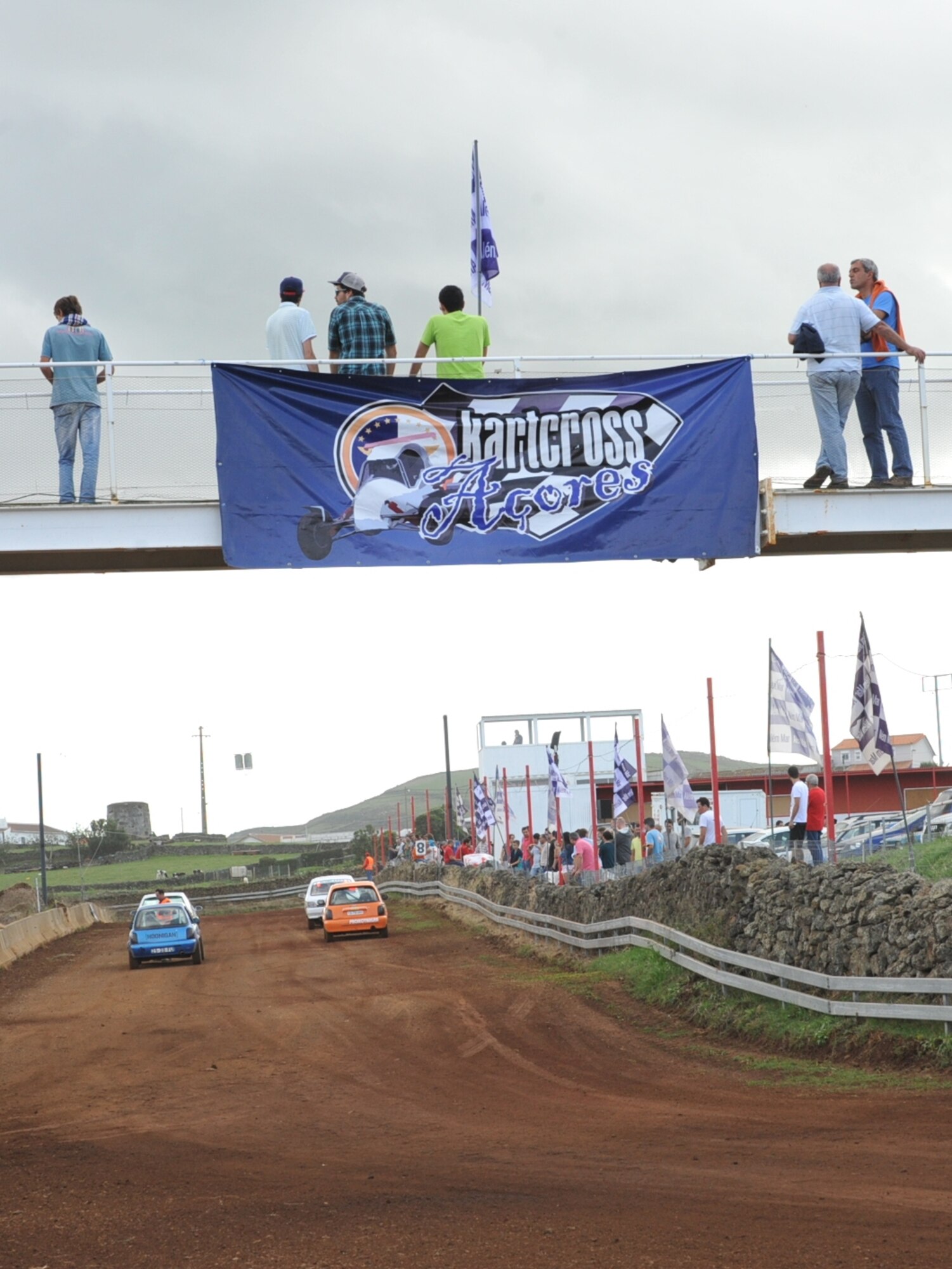 U.S. Air Force Staff Sgt. Joshua VanHorn, 65th Medical Operations Squadron medical technician, and several Portuguese race car drivers wait for the start signal during a rally race in Praia da Vitoria, Azores. VanHorn competes in car races with Portuguese local nationals in the Azores while building friendships and host nation relations within the local community. As the only U.S. participant, VanHorn displays an American flag with his last name on his rear driver's-side window. (U.S. Air Force photo by Staff Sgt. Angelique N. Smythe/Released)