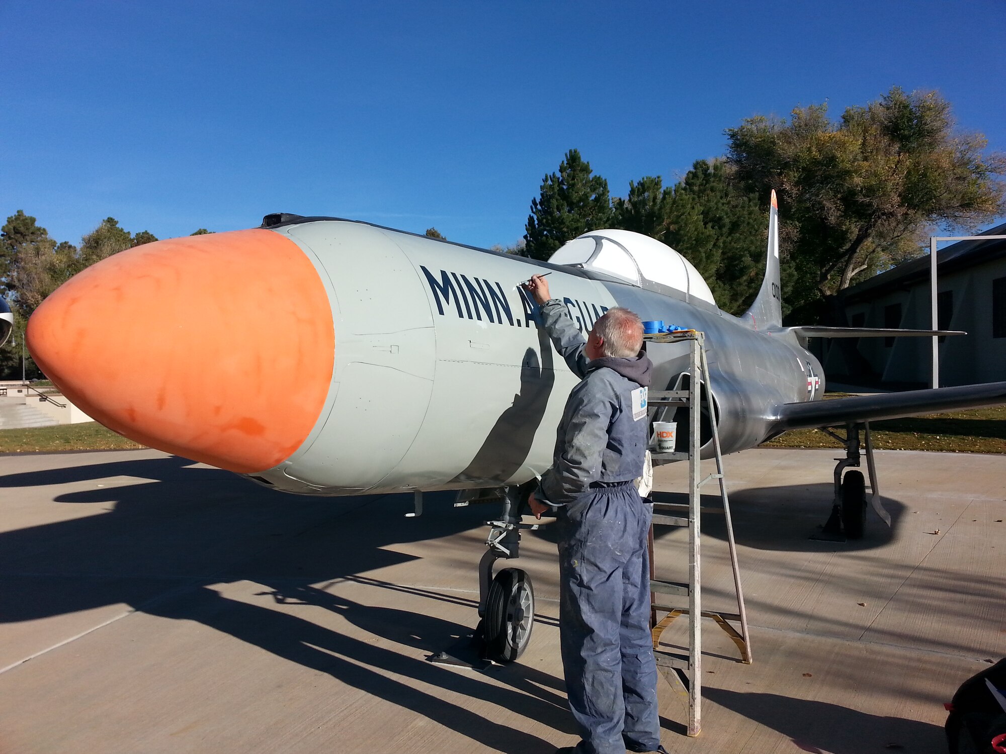 PETERSON AIR FORCE BASE, Colo. -- Jerry Shindall, a contractor with Enviro-Tech, Inc., applies detailed colors and markings to the Peterson Air and Space Museum’s F-94. The F-94 Starfire got a facelift Oct. 14-18, complete with fresh markings representing the 179th Fighter Interceptor Squadron, Minnesota Air National Guard, which operated the aircraft from 1957 to 1959. First flown in 1949, the Lockheed F-94 was used for air defense of the continental United States in the 1950s. Starfires were the U.S. Air Force's first all-weather jet interceptor. (U.S. Air Force photo/Jeff Nash)