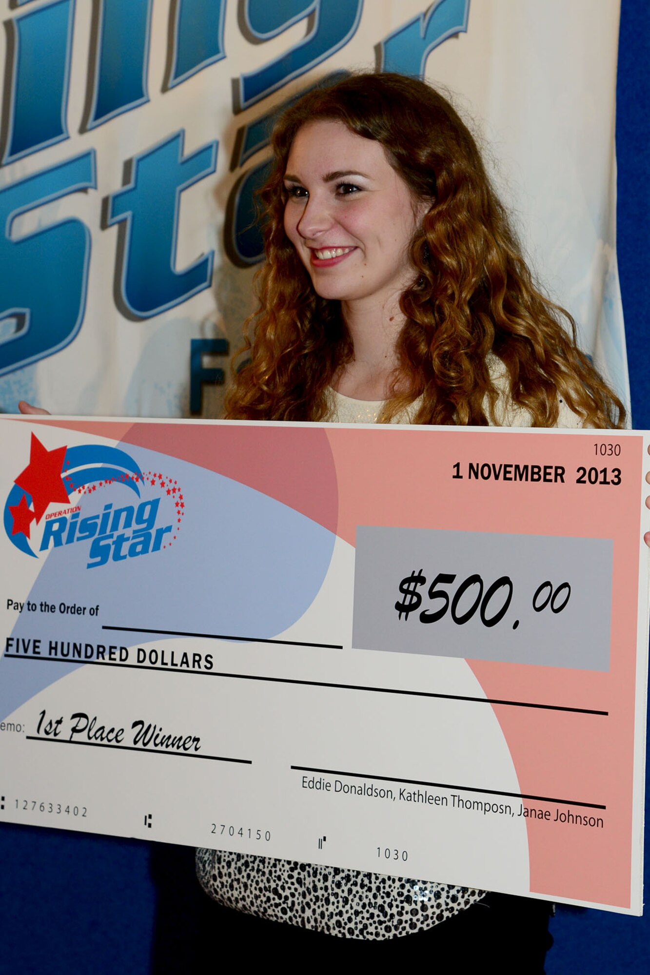 Sarah Hopkins won $500 as first-place winner of the Operation Rising Star competition at Fort Eustis, Va., Nov. 1, 2013. The rules of the event are similar to television shows such as “American Idol” and “The Voice,” in which 50 percent of the contestants’ outcome comes from audience response, and the other half comes from the judges' decisions. (U.S. Air Force photo by Staff Sgt. Ashley Hawkins/Released)