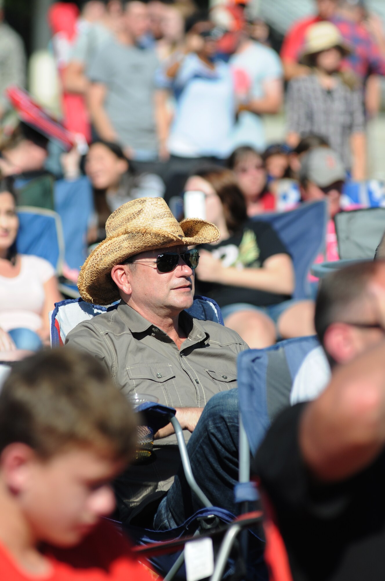 Maj. Gen. Leonard Patrick , 2nd Air Force commander, sits in the crowd during a concert by country music singer, Rodney Atkins, Nov. 2, 2013, at the Triangle Parade Field, Keesler Air Force Base, Miss.  Local band Autumn Rise-N also performed.  (U.S. Air Force photo by Kemberly Groue)