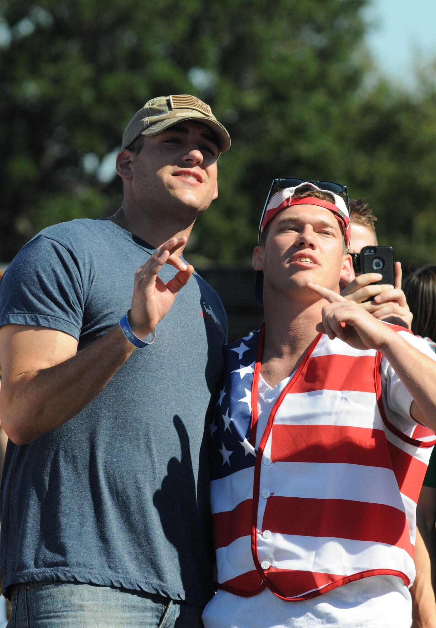 Airmen 1st Class Jesse Dieter and Kendall Davis, 335th Training Squadron, sing along with country music singer, Rodney Atkins, during a concert Nov. 2, 2013, at the Triangle Parade Field, Keesler Air Force Base, Miss.  Local band Autumn Rise-N also performed.  (U.S. Air Force photo by Kemberly Groue)