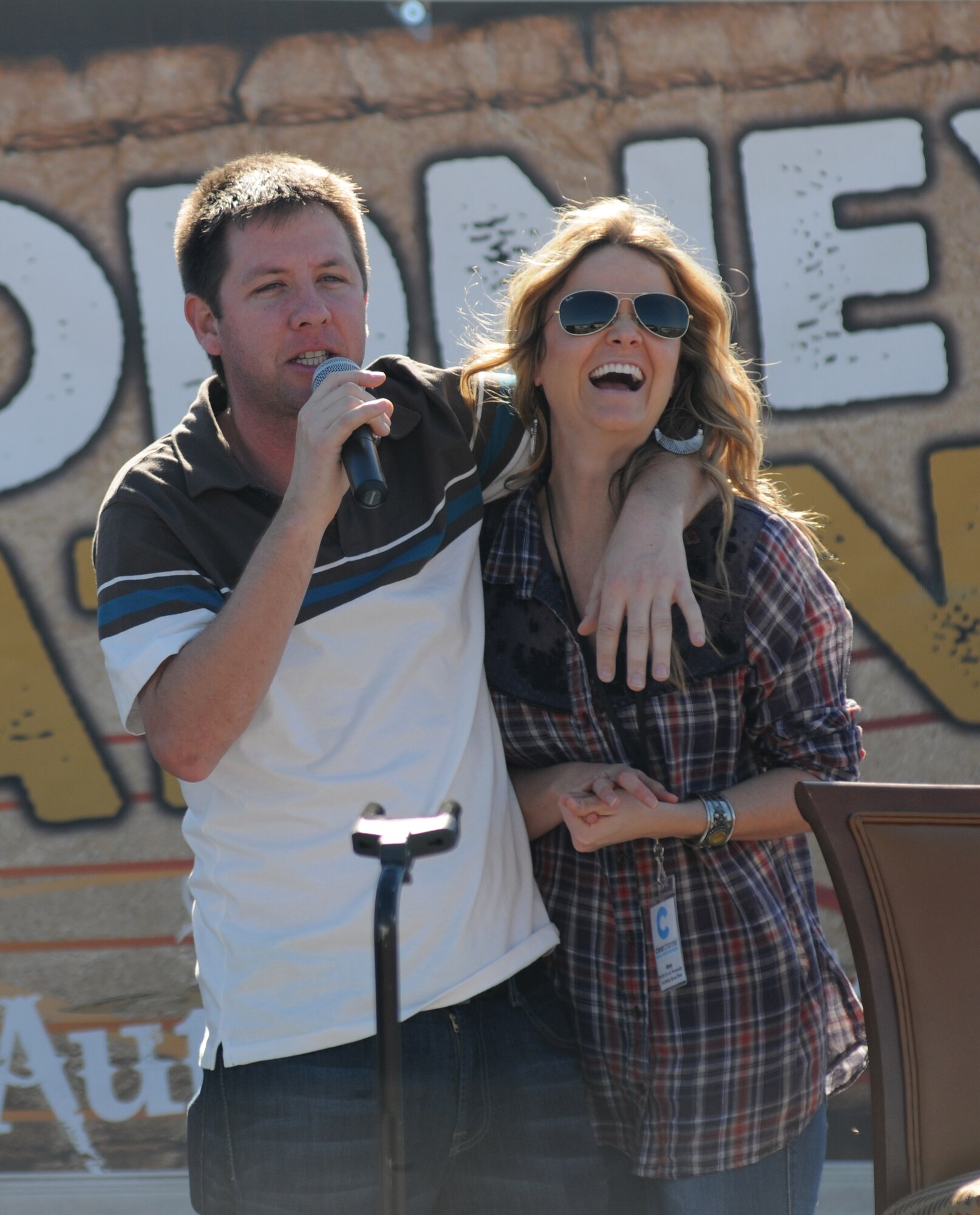 Lunchbox and Amy from the “Bobby Bones Radio Show” introduce country music singer, Rodney Atkins, to the stage during a concert Nov. 2, 2013, at the Triangle Parade Field, Keesler Air Force Base, Miss.  Local band Autumn Rise-N also performed.   (U.S. Air Force photo by Kemberly Groue)
