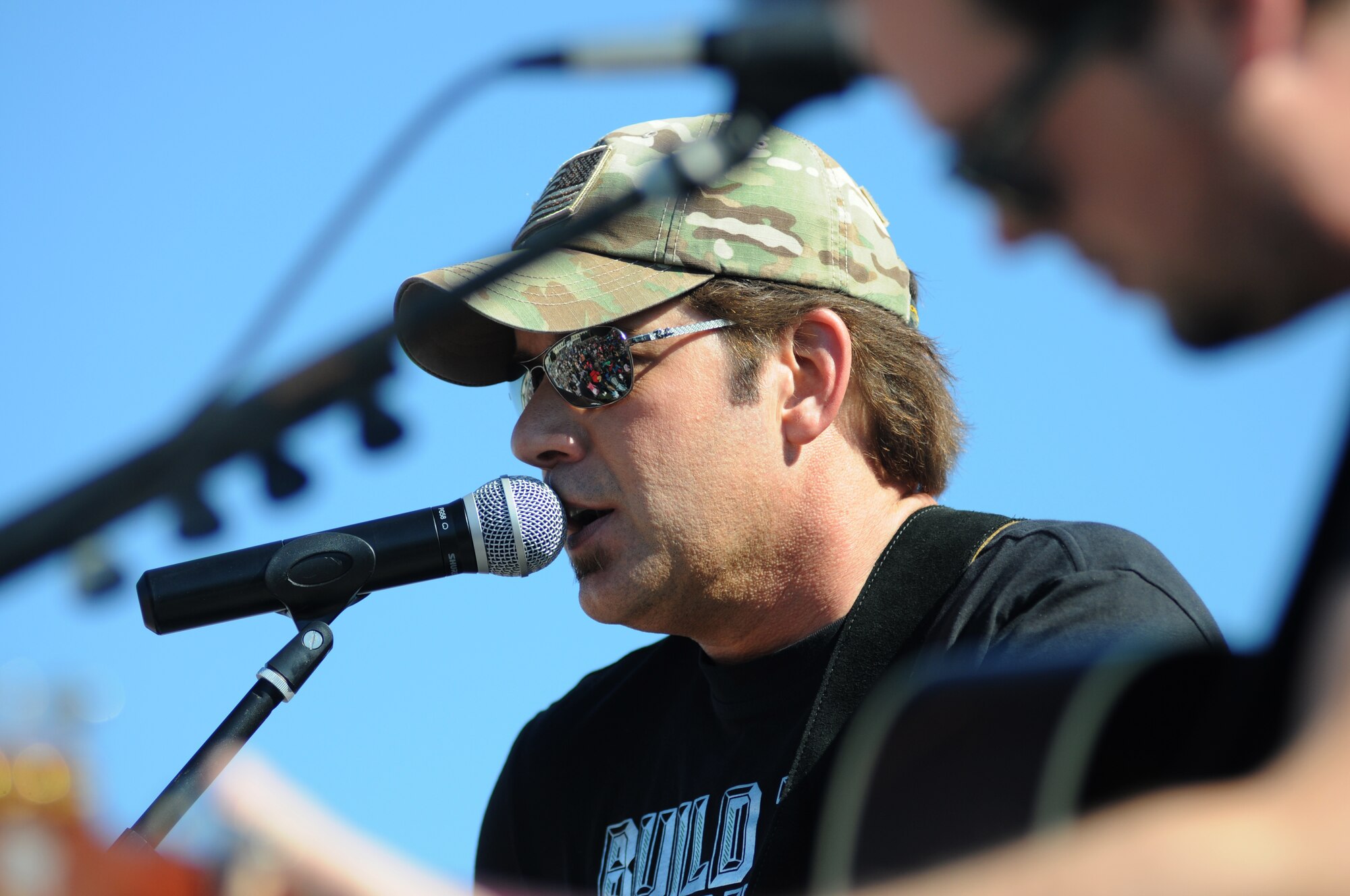 Country singer Rodney Atkins performs with Liam Bailey during a concert Nov. 2, 2013, at the Triangle Parade Field, Keesler Air Force Base, Miss.  Local band, Autumn Rise-N, also performed.  (U.S. Air Force photo by Kemberly Groue)