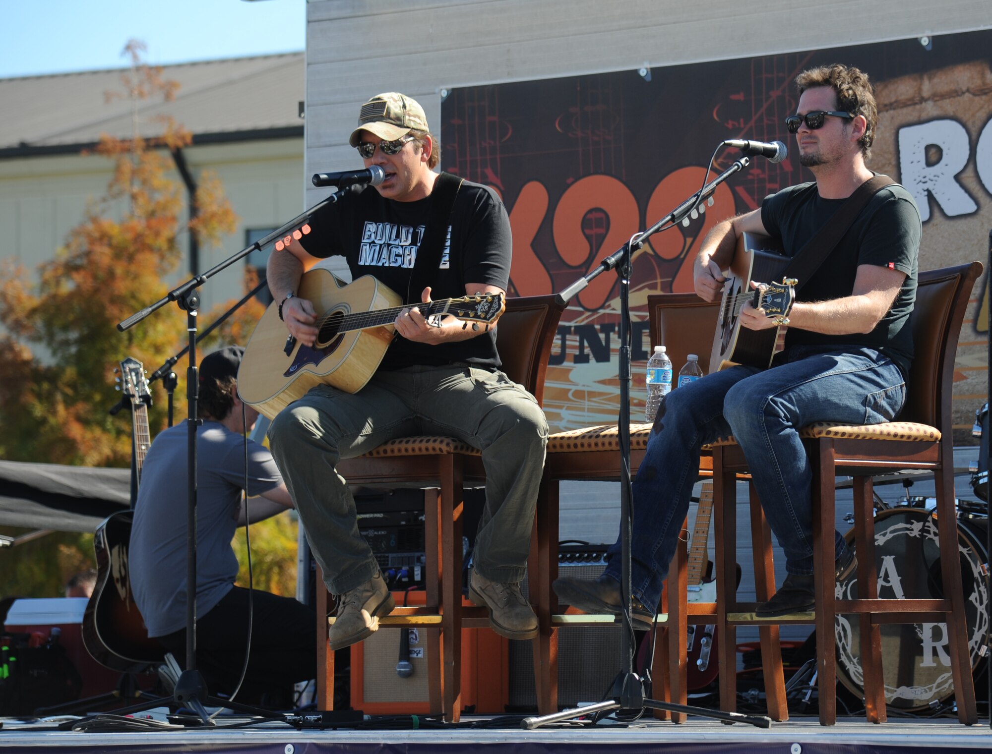 Country singer Rodney Atkins performs with Liam Bailey during a concert Nov. 2, 2013, at the Triangle Parade Field, Keesler Air Force Base, Miss.  Local band, Autumn Rise-N, also performed.  (U.S. Air Force photo by Kemberly Groue)