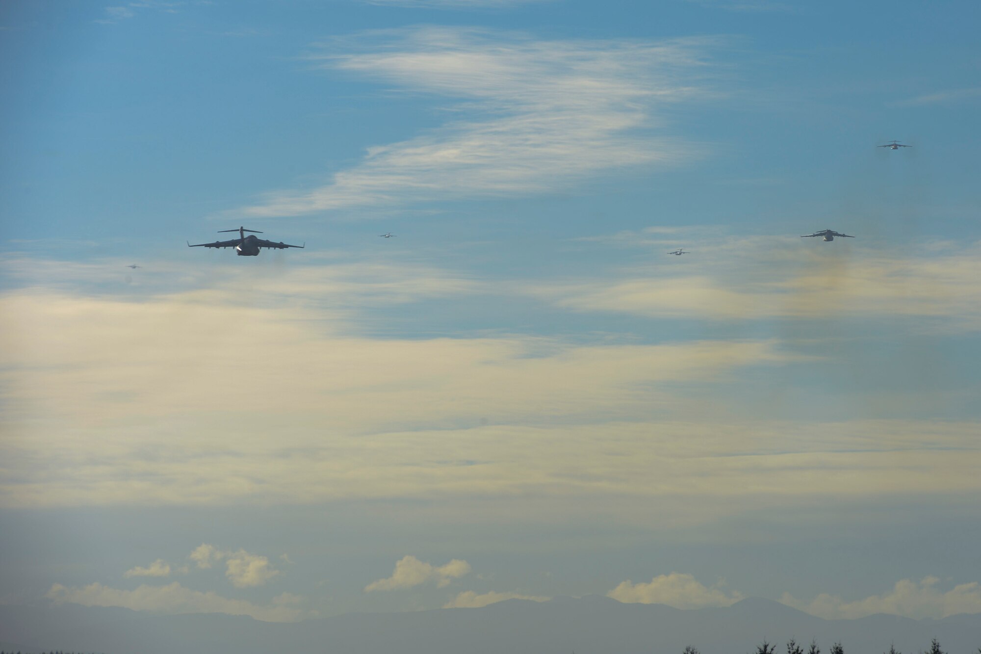 Six C-17 Globemaster III aircraft depart McChord Field in a 6-ship formation, Nov. 4, 2013 at Joint Base Lewis-McChord, Wash. The formation was performed as part of a multi-faceted joint force training exercise promoting readiness and precision large-scale movement of government assets. (U.S. Air Force Photo/Airman 1st Class Jacob Jimenez)  