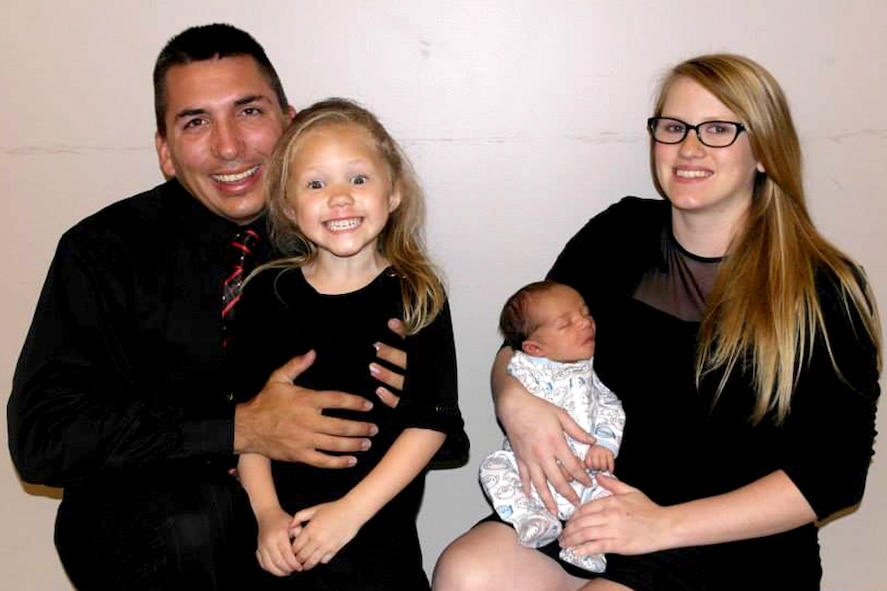 U.S. Air Force Senior Airman Shane Strunk, 4th Equipment Maintenance Squadron phase dock crew chief, poses for a family portrait in 2013. Strunk was deployed for the majority of his wife’s pregnancy and missed the birth of his son by two weeks. During the month of November, military families are recognized by the Department of Defense and the nation for the sacrifices they make in support of the country. (Courtesy Photo) 