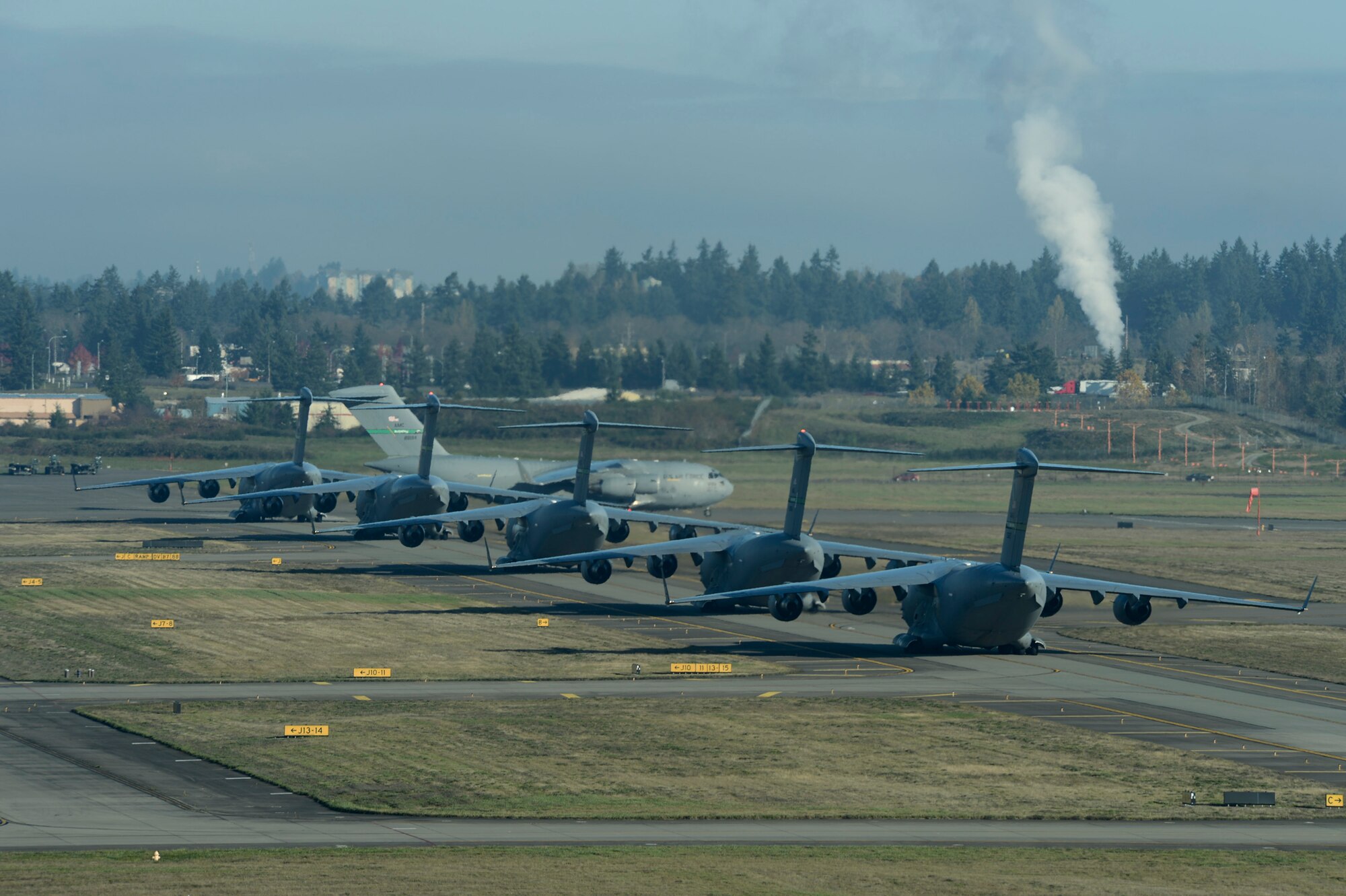 Six C-17 Globemaster III aircraft taxi to the McChord Field runway prior to takeoff, Nov. 4, 2013 at Joint Base Lewis-McChord, Wash. The 6-ship formation was part of a training mission to Mountain Home, Idaho, simulating a large-scale force-entry deployment. (U.S. Air Force Photo/Airman 1st Class Jacob Jimenez) 