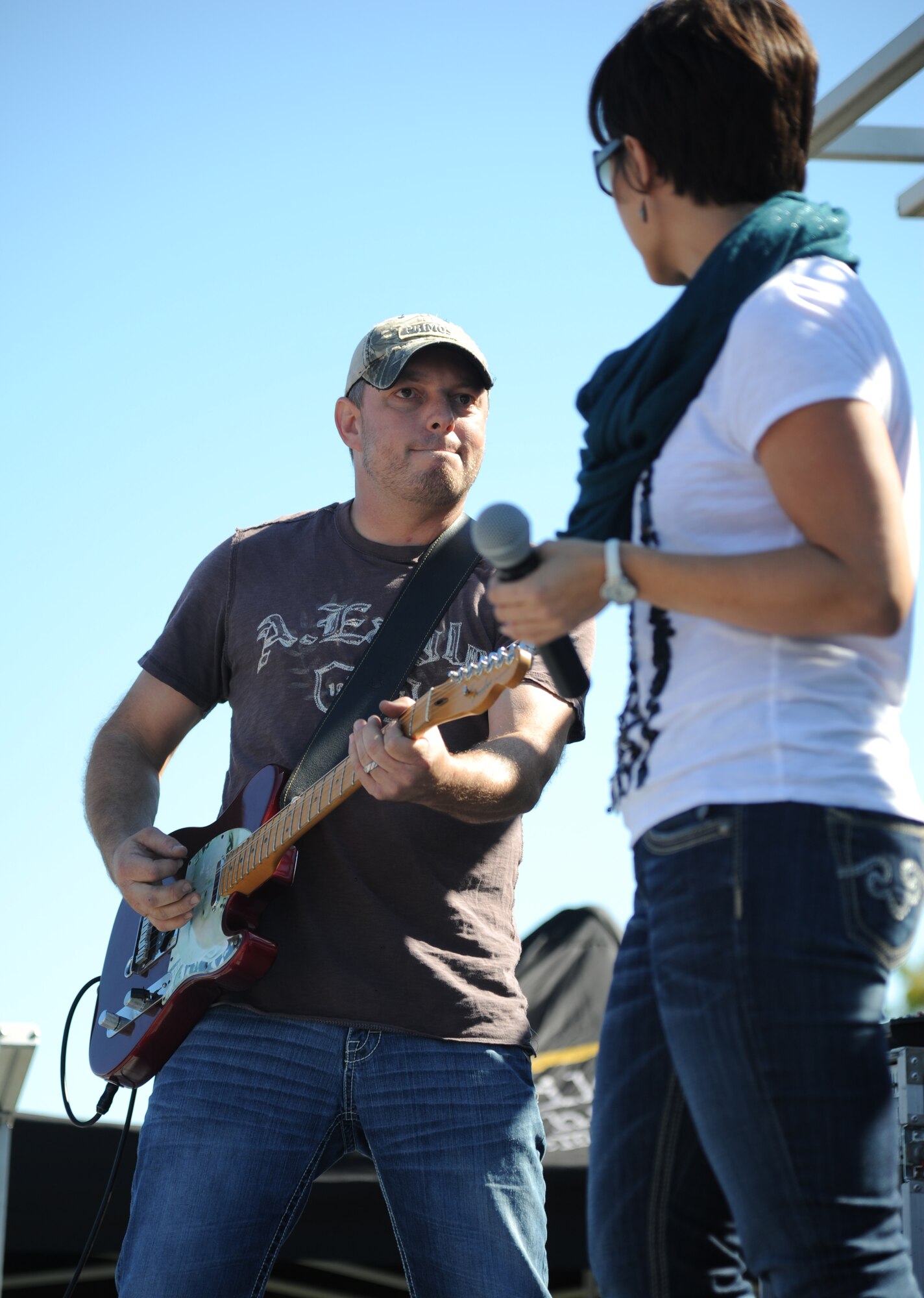Chris Bayless and Ashley Hamner of the local band Autumn Rise-N deliver a pre-show performance for the Rodney Atkins concert Nov. 2, 2013, at the Triangle Parade Field, Keesler Air Force Base, Miss.  Airmen and Keesler personnel attended the event.  (U.S. Air Force photo by Kemberly Groue)