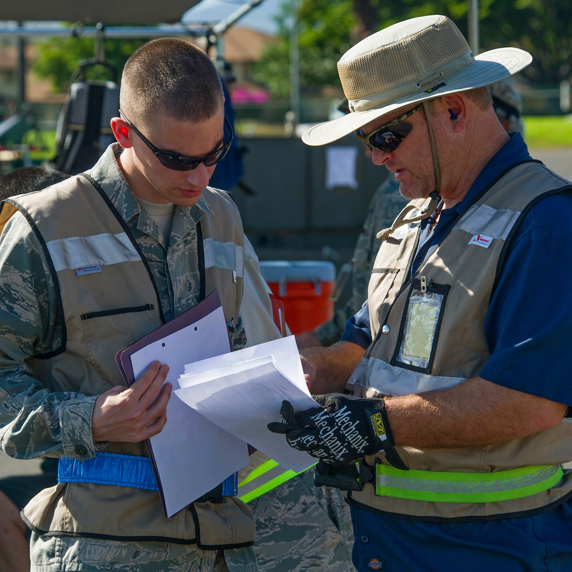 Airman 1st Class Joshua Mattlach, 15th Aircraft Maintenance Squadron guidance and control, left, gets his shipping documentation checked for accuracy by Micheal Kuklok, Naval Facilities Base Services Vehicle Equipment, cargo in-check lead, right, near the flightline during an Operational Readiness Inspection at Joint Base Pearl Harbor-Hickam, Hawaii, Nov. 3, 2013. The Consolidated Unit Inspection is designed to evaluated 15th Wing and 154th Wing capabilities to respond to real world contingencies.  (U.S. Air Force photo/Tech. Sgt. Jerome Tayborn)