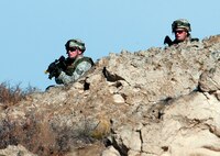 Staff Sgt. Samuel Saintz, 791st Missile Security Forces Squadron team leader (left) and Tech. Sgt. Jason Cummings, 791st MSFS flight chief (right) move in on the opposition forces during a convoy protection exercise at Camp Guernsey, Wyo., Oct. 30, 2013. The Minot Air Force Base defenders were taking part in the annual exercise conducted by the 620th Ground Combat Training Squadron which train Airmen of the 20th Air Force missile wings in the defense of nuclear assets should they come under attack while being transported in convoys. (U.S. Air Force photo by R.J. Oriez)