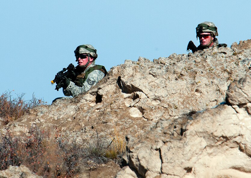 Staff Sgt. Samuel Saintz, 791st Missile Security Forces Squadron team leader (left) and Tech. Sgt. Jason Cummings, 791st MSFS flight chief (right) move in on the opposition forces during a convoy protection exercise at Camp Guernsey, Wyo., Oct. 30, 2013. The Minot Air Force Base defenders were taking part in the annual exercise conducted by the 620th Ground Combat Training Squadron which train Airmen of the 20th Air Force missile wings in the defense of nuclear assets should they come under attack while being transported in convoys. (U.S. Air Force photo by R.J. Oriez)