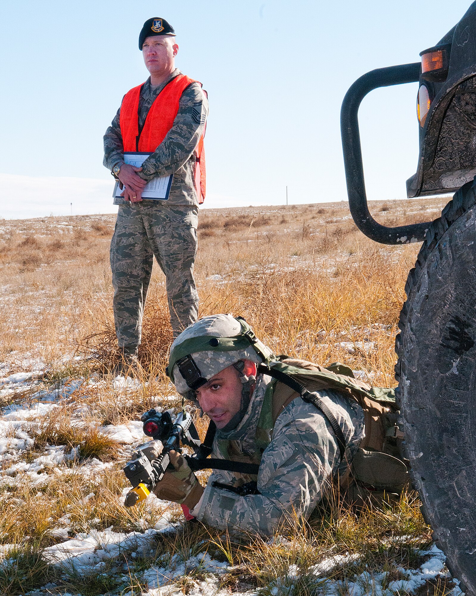 Staff Sgt. Joseph Misciagna, 791st Missile Security Forces Squadron team leader mans a defensive position under the watchful eye of a 620th Ground Combat Training Squadron instructor during a convoy protection exercise at Camp Guernsey, Wyo., Oct. 30, 2013. The Minot Air Force Base defenders were taking part in the annual exercise conducted by the 620th GCTS which train Airmen of the 20th Air Force missile wings in the defense of nuclear assets should they come under attack while being transported in convoys. (U.S. Air Force photo by R.J. Oriez) 