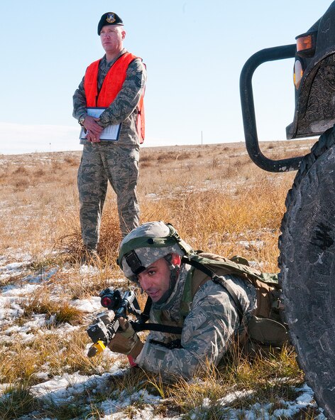Staff Sgt. Joseph Misciagna, 791st Missile Security Forces Squadron team leader mans a defensive position under the watchful eye of a 620th Ground Combat Training Squadron instructor during a convoy protection exercise at Camp Guernsey, Wyo., Oct. 30, 2013. The Minot Air Force Base defenders were taking part in the annual exercise conducted by the 620th GCTS which train Airmen of the 20th Air Force missile wings in the defense of nuclear assets should they come under attack while being transported in convoys. (U.S. Air Force photo by R.J. Oriez) 