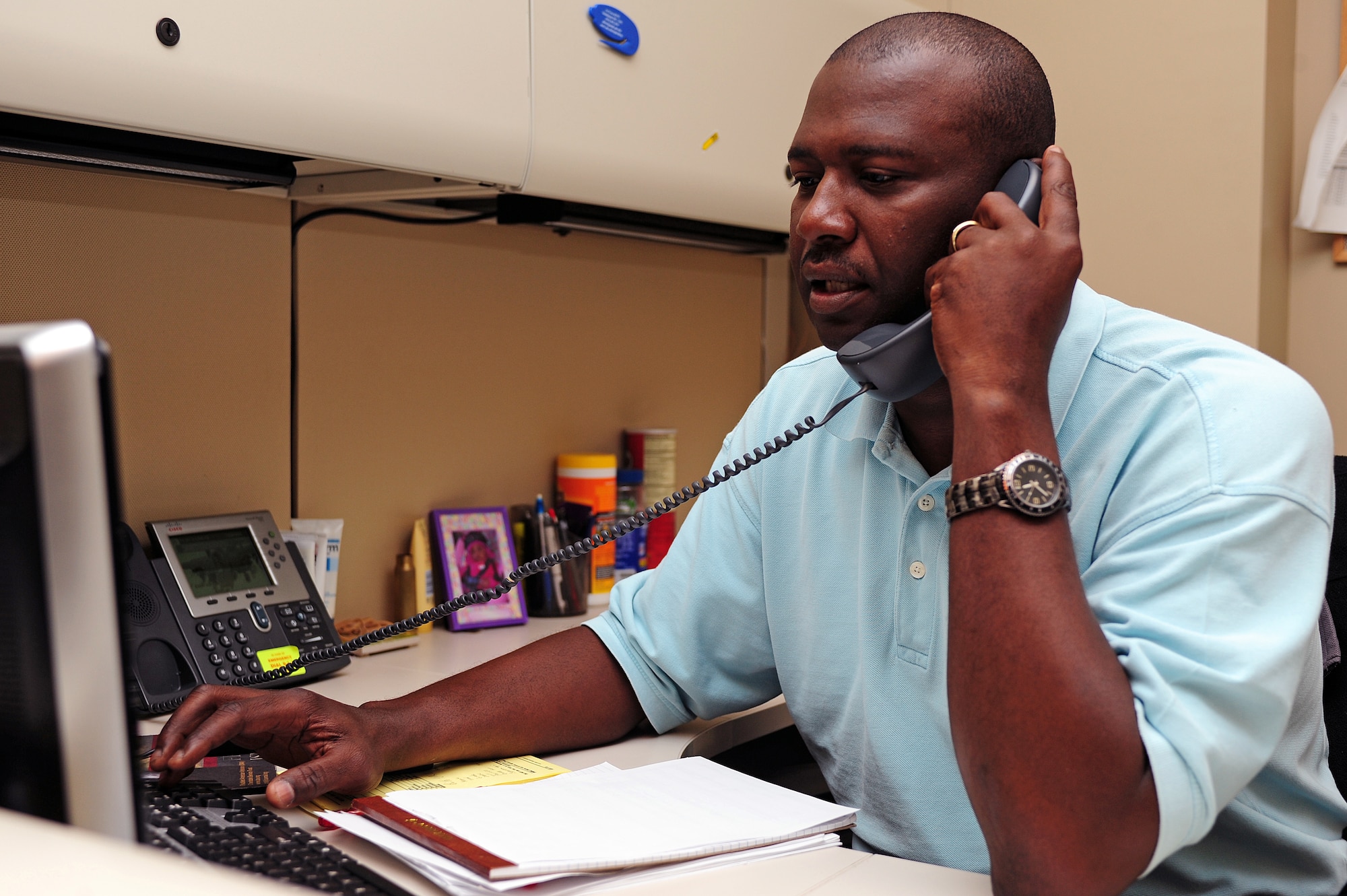 Ret. Master Sgt. Milford Nickerson, 4th Comptroller Squadron unit program coordinator, assists a customer over the phone at Seymour Johnson Air Force Base, N.C., Nov. 4, 2013. Nickerson said Veteran’s Day, to him, means honoring those who sacrificed a time in their life to serve in the military, whether it was for multiple enlistments or just one. (U.S. Air Force photo by Airman 1st Class John Nieves Camacho)